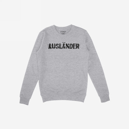 Light-gray long-sleeve crewneck sweatshirt with AUSLÄNDER in distressed black print across the chest, representing empowerment and resilience, part of the Ausländer Hoodie & Sweatshirt collection.