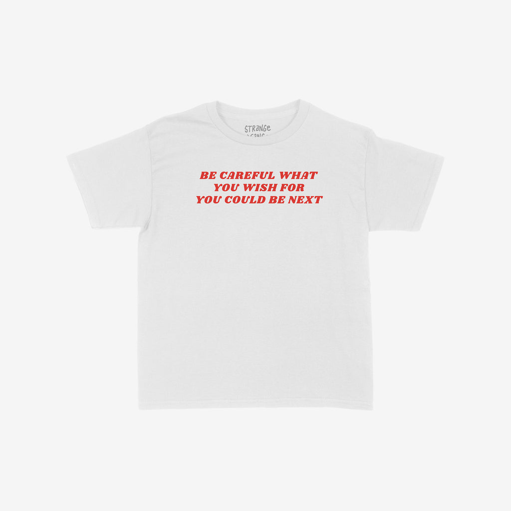 Be Careful Women's Baby Tee features bold red text, BE CAREFUL WHAT YOU WISH FOR YOU COULD BE NEXT, on a white cropped tee, combining style with a powerful anti-authoritarian message.