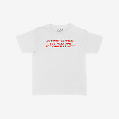 Be Careful Women's Baby Tee features bold red text, BE CAREFUL WHAT YOU WISH FOR YOU COULD BE NEXT, on a white cropped tee, combining style with a powerful anti-authoritarian message.