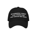 Black Be Careful Hat with white embroidered warning: “BE CAREFUL WHAT YOU WISH FOR YOU COULD BE NEXT”, embodying a bold p