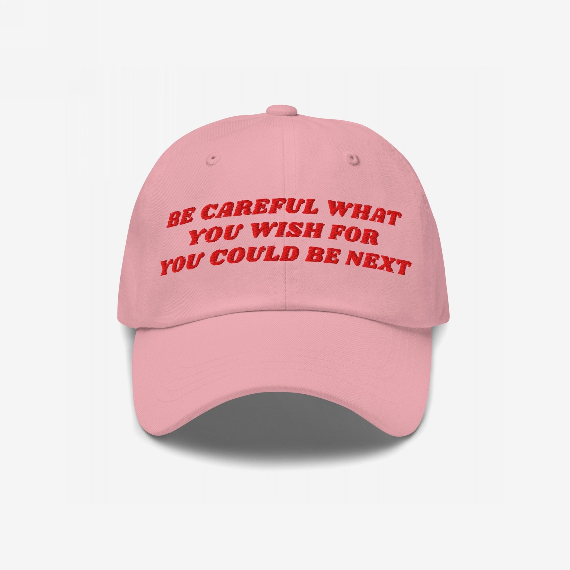 Pink 'Be Careful Hat' with bold red embroidery reads “BE CAREFUL WHAT YOU WISH FOR YOU COULD BE NEXT.” A stylish statement accessory supporting equality and activism.