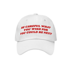 White baseball-style cap with red embroidered text Be Careful What You Wish For You Could Be Next, designed for anti-fascists