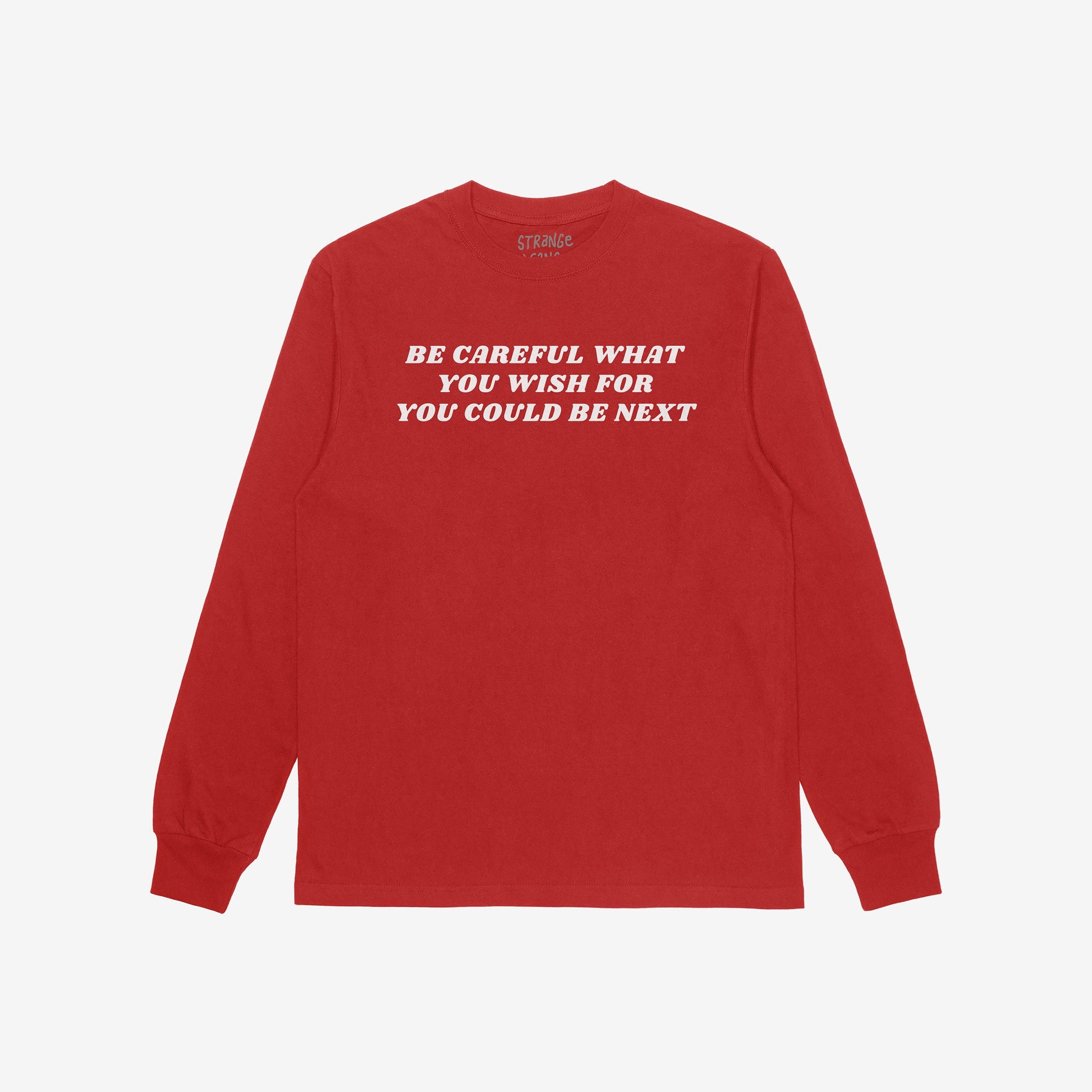 Red long-sleeved Be Careful T-shirt featuring bold white slogan advocating against authoritarianism. The retro typography conveys a rebellious stance, aligning with the ethos of challenging power structures.