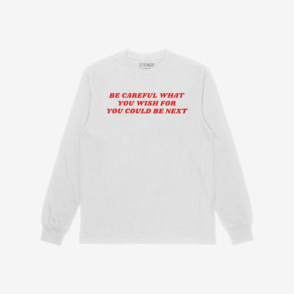 Be Careful T-shirt features bold red lettering on a white long-sleeve, expressing defiance against authoritarianism. The striking slogan challenges and empowers, embodying a rebellious stance against oppressive power.