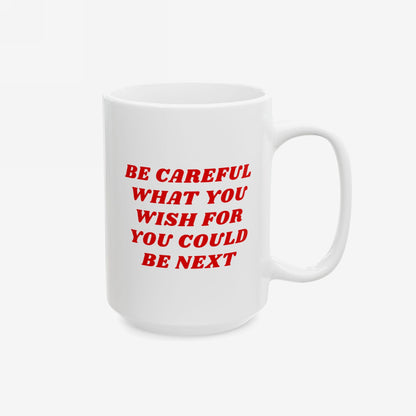 The Be Careful Mug features bold red text, BE CAREFUL WHAT YOU WISH FOR YOU COULD BE NEXT, on a white ceramic surface, highlighting progressive values with a stark message.