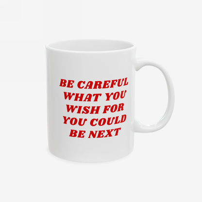 The Be Careful Mug features bold red text warning BE CAREFUL WHAT YOU WISH FOR YOU COULD BE NEXT on a white ceramic surface, embodying a strong message for progressive thinkers.