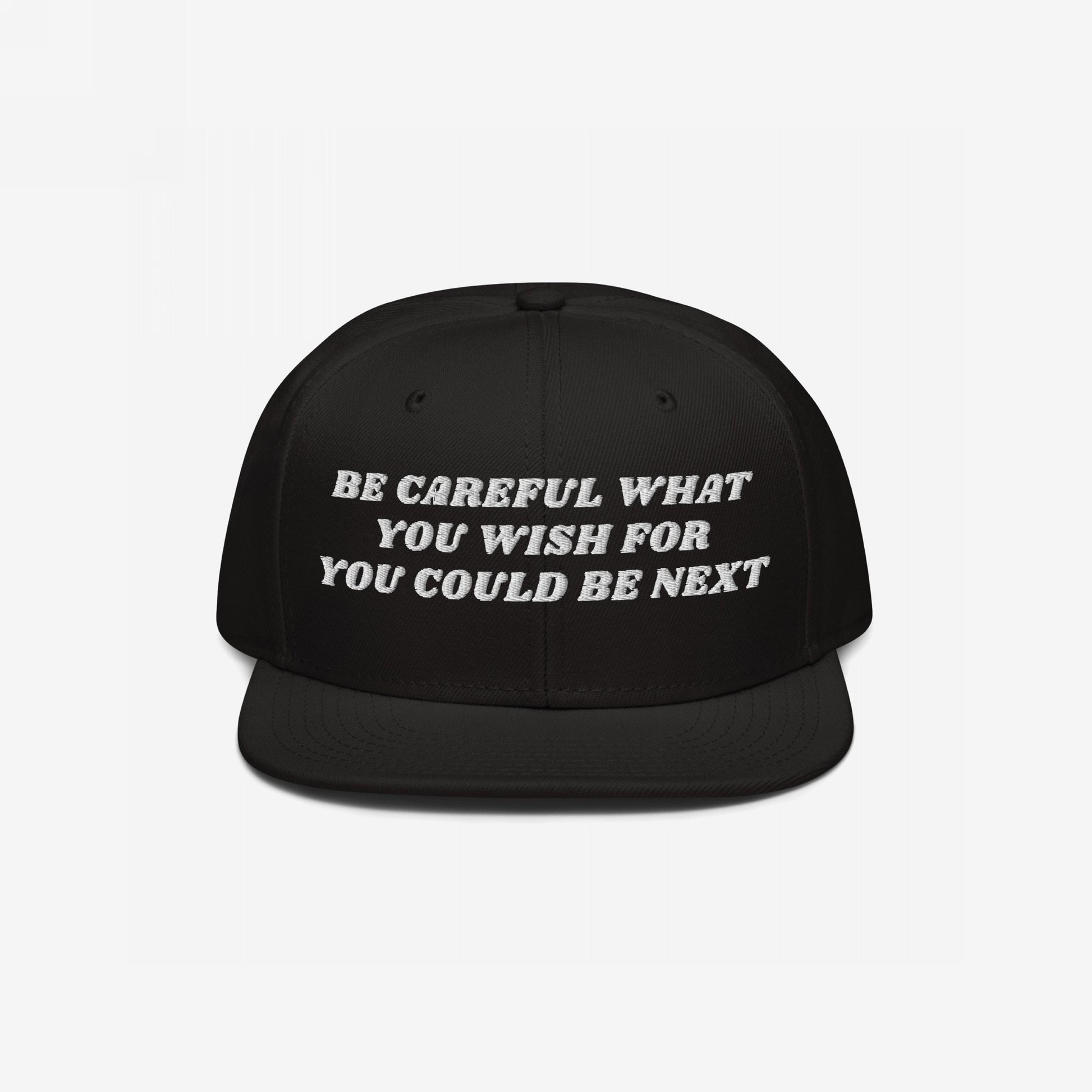 Black flat-brim snapback hat with white embroidered text: Be Careful What You Wish For - You Could Be Next. This Be Careful Hat delivers a bold message, merging style with activism.