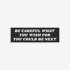 Be Careful Sticker & Magnet featuring a bold message overlay on a crowd, urging awareness. Available as a sticker or magnet, it supports ACLU and advocates against fascism.