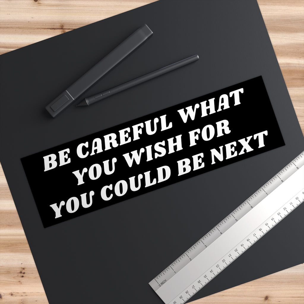 Be Careful Sticker & Magnet, featuring bold text, lies on a black mat with a stylus and ruler. This product offers a reality check message, perfect for adding a thought-provoking touch to personal spaces.