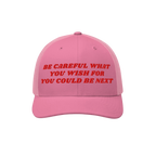 The Be Careful Hat features bold red embroidery on a pink trucker cap, delivering a sharp political message ideal for progres