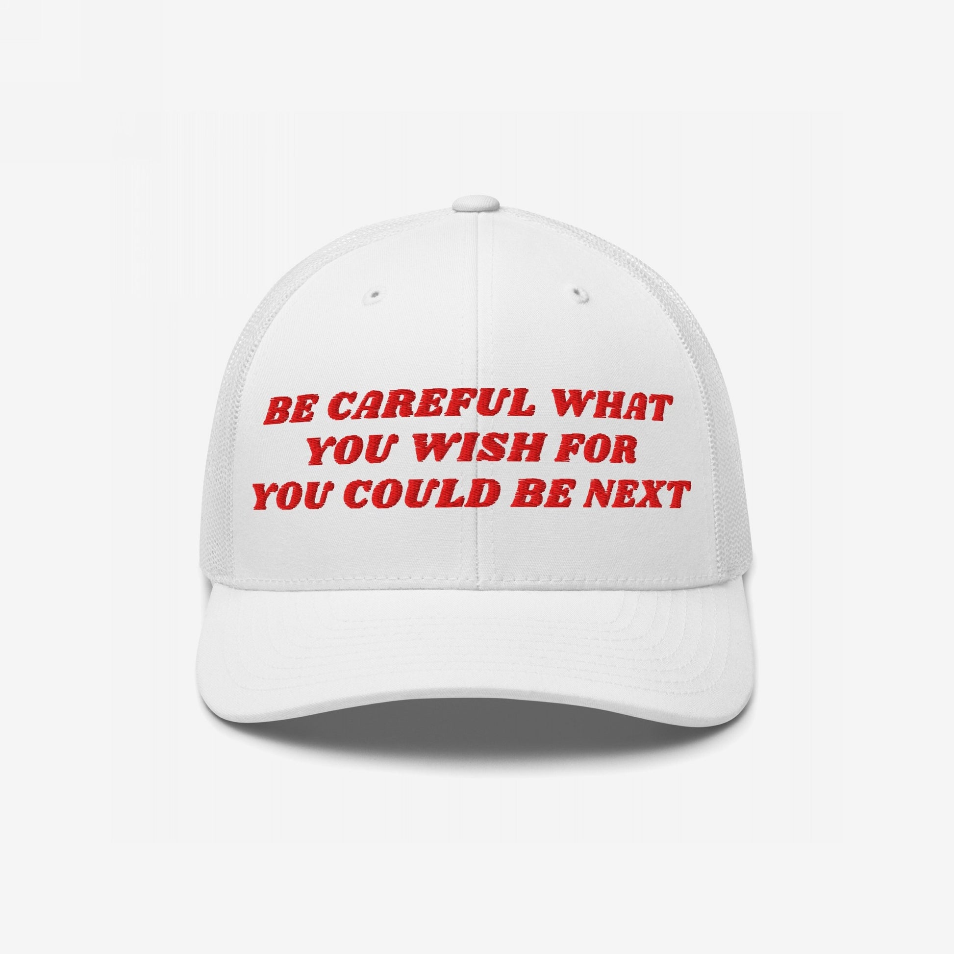 White baseball cap with red embroidery reading Be Careful What You Wish For / You Could Be Next, echoing a bold message of caution and empowerment.