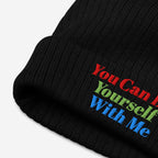 Black rib-knit Be Yourself Hat featuring a vibrant three-line slogan embroidered in red, green, and blue, promoting individuality and inclusivity with You Can Be Yourself With Me message.