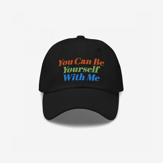 Black "Be Yourself Hat" with colorful embroidered text "You Can Be Yourself With Me" on front, promoting acceptance and authenticity.