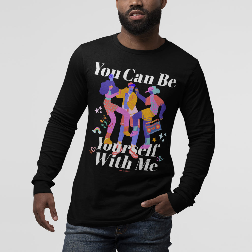 The Be Yourself Shirt features vibrant abstract figures with musical notes and stars on a black long-sleeve tee, promoting self-expression and inclusivity.