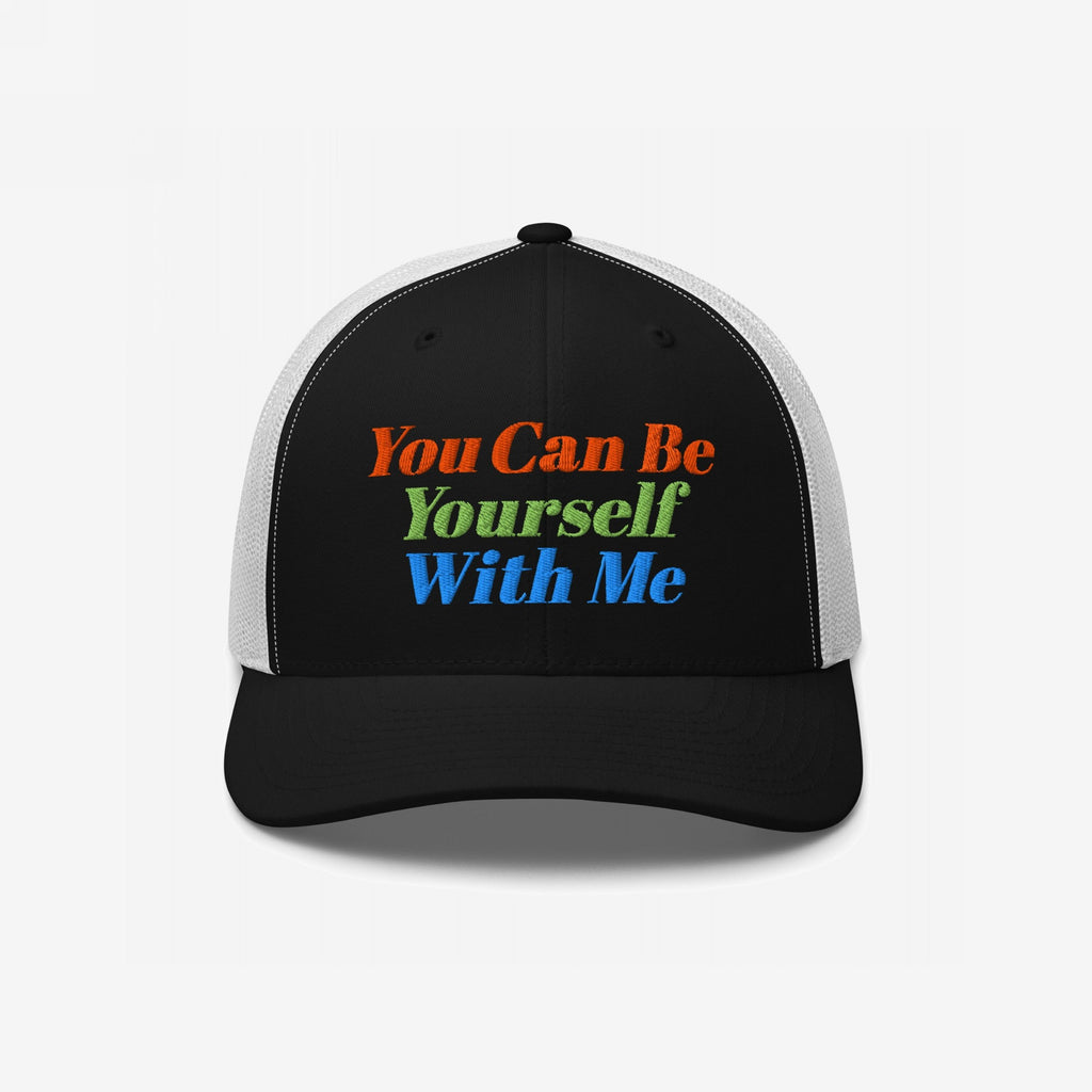 Black-front, white-mesh trucker cap with vibrant embroidery reading “You Can Be Yourself With Me,” embodying self-expression and inclusivity. Perfect for those embracing individuality and spreading positive messages.