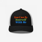 Black-front, white-mesh trucker cap with vibrant embroidery reading “You Can Be Yourself With Me,” embodying self-expression and inclusivity. Perfect for those embracing individuality and spreading positive messages.