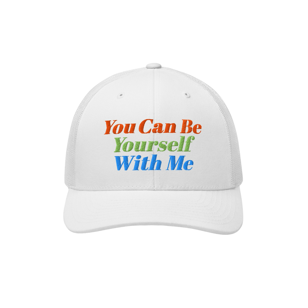The Be Yourself Hat features a white trucker-style cap with bold embroidery that reads, You Can Be Yourself With Me, embodyin