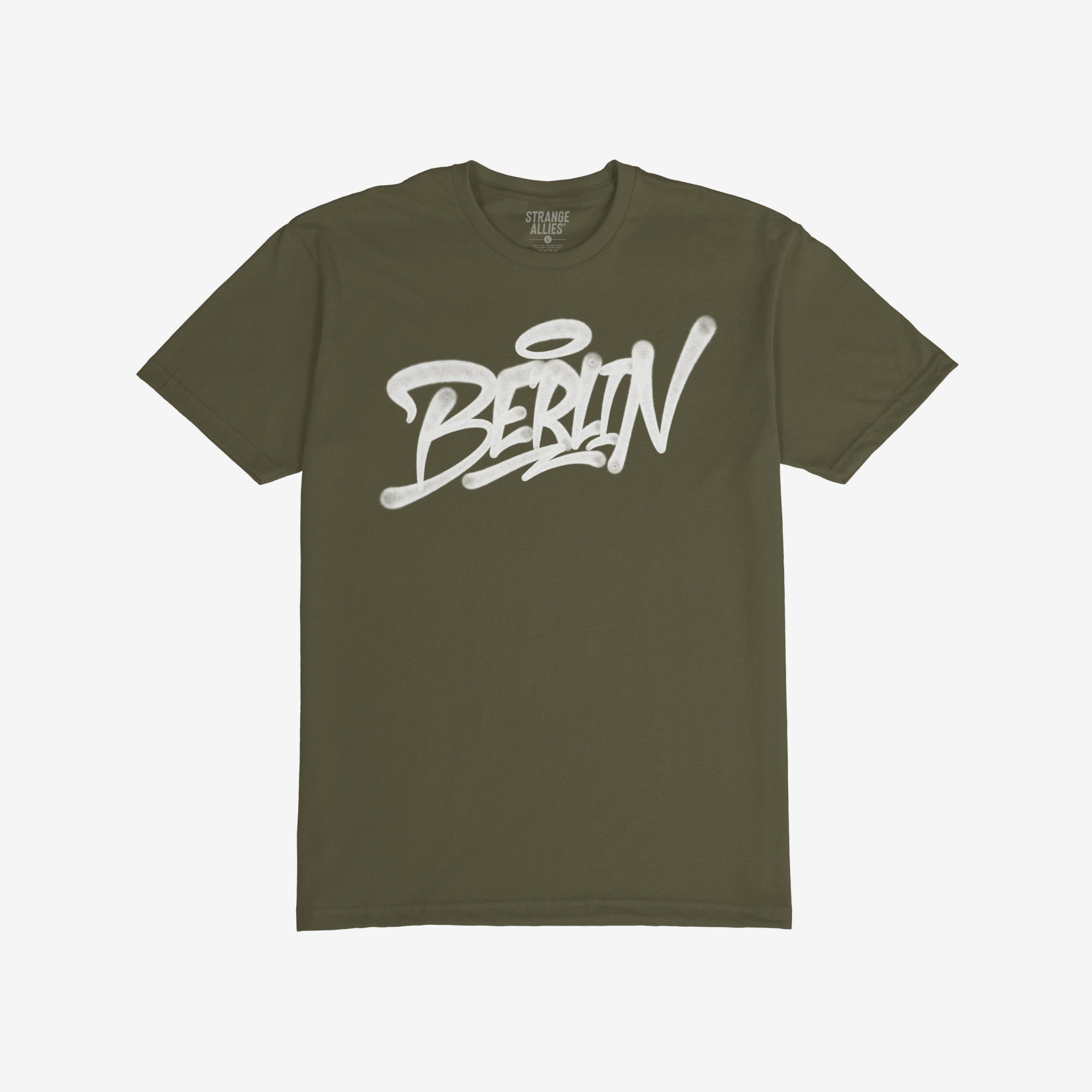 Olive-green Berlin Handstyle T-shirt featuring bold white graffiti-style text with a halo accent over the “i,” embodying urban street art style and rebellious spirit.