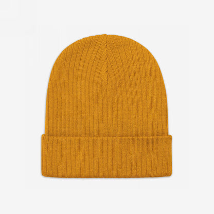 Knit Beanie In Custom Colors features a warm mustard-yellow, rib-knit design with a turned-up cuff, embodying political and anti-fascist statements. Made from recycled polyester, it combines style with activism.