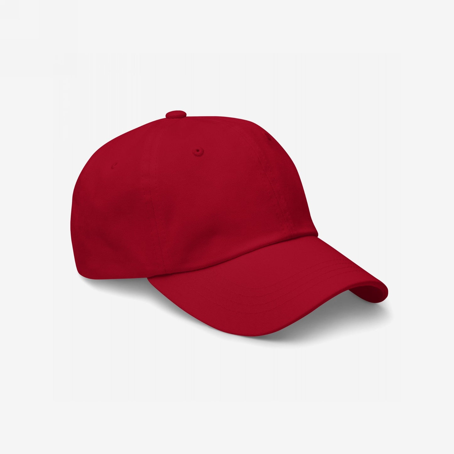 Dad Hat In Custom Colors: A plain red, six-panel baseball cap against a white background, showcasing its low-profile, unstructured design. Perfect for displaying embroidered anti-fascist or activist messages.