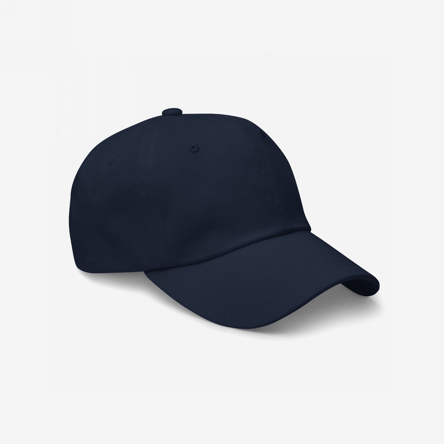 Dad Hat In Custom Colors: A plain, dark-navy baseball cap with a curved brim. Made from soft chino cotton twill, it features an adjustable back strap and antique buckle for a comfortable fit.