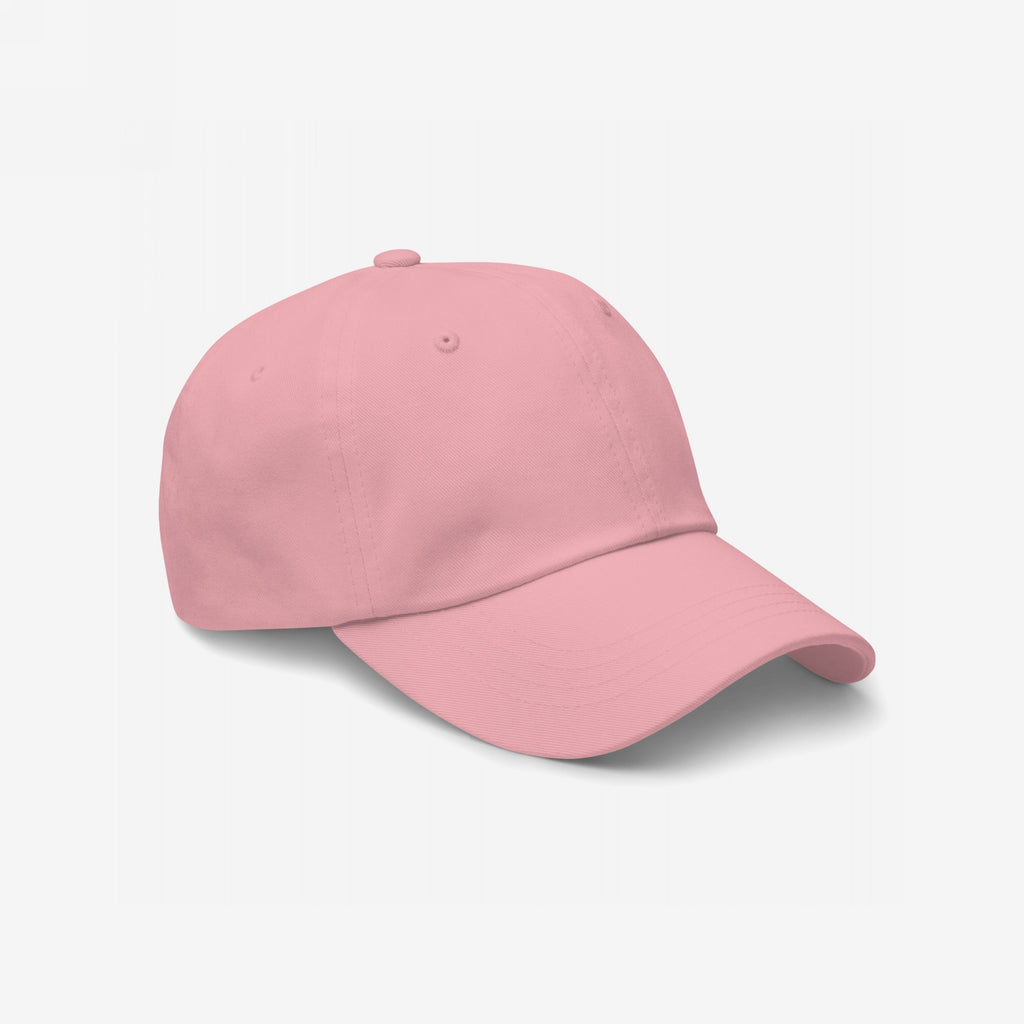 Dad Hat In Custom Colors features a soft pink, unstructured baseball cap, viewed at a slight angle, highlighting its casual style, perfect for personalizing with meaningful embroidered activist designs.