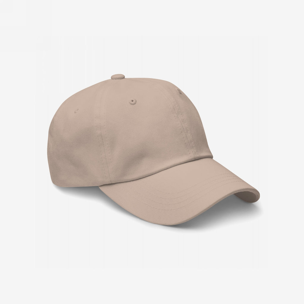 Dad Hat In Custom Colors, plain light-beige six-panel design on white background, ready for custom anti-fascist or activist embroidery. Made from soft chino cotton, featuring an adjustable strap and antique buckle.