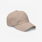Dad Hat In Custom Colors, plain light-beige six-panel design on white background, ready for custom anti-fascist or activist embroidery. Made from soft chino cotton, featuring an adjustable strap and antique buckle.