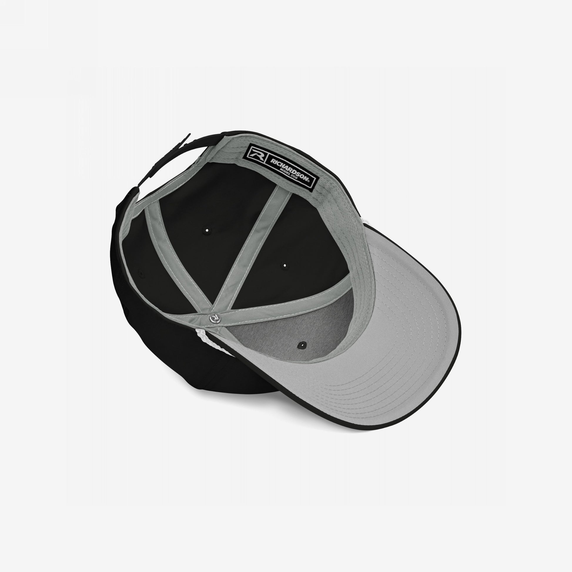 Golf Hat In Custom Colors, showcasing the interior design with medium gray crown panels and a black interior, featuring an adjustable strap and Richardson label, highlighting its progressive style and comfort.