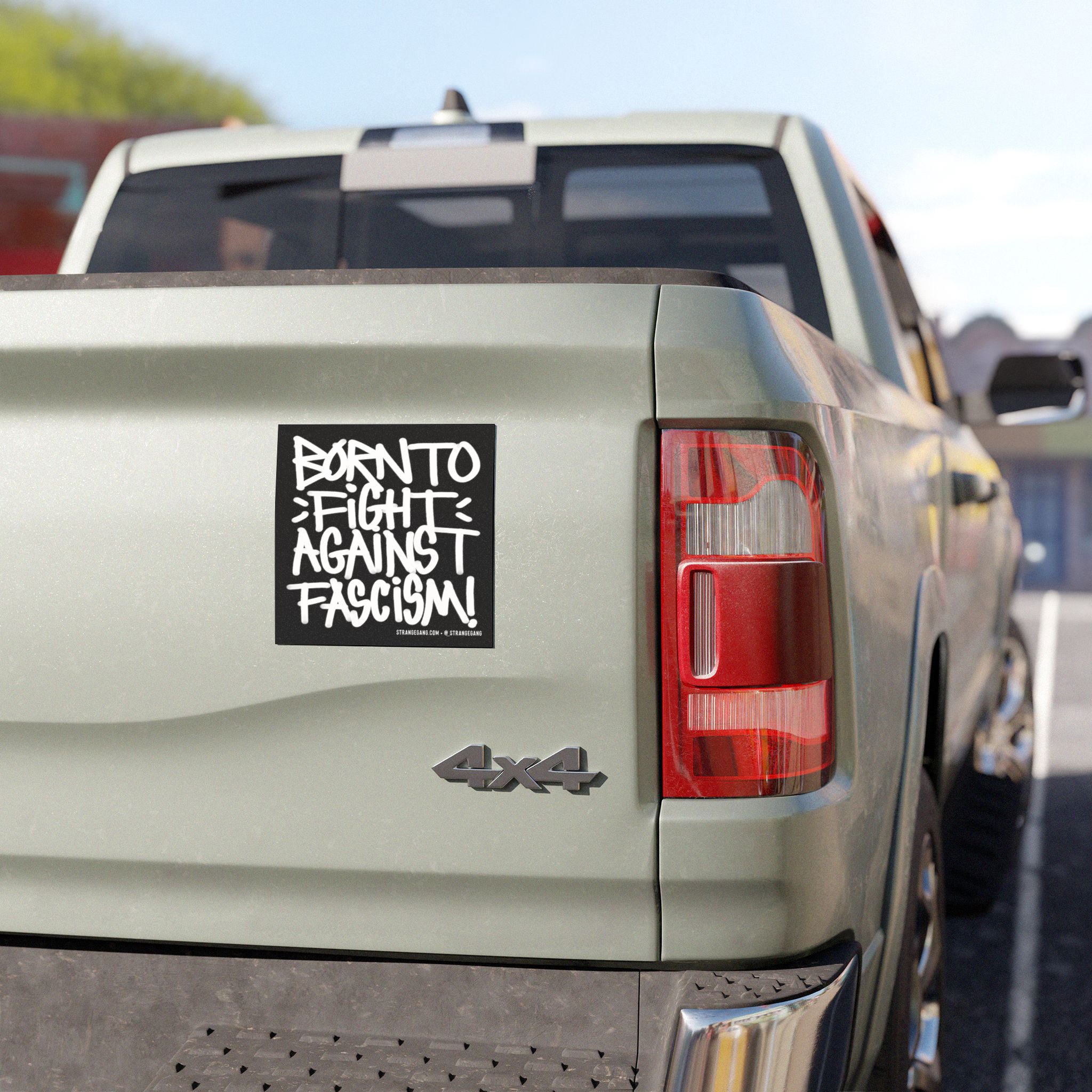 The image displays the Born To Fight Against Fascism Graffiti Sticker & Magnet on a pickup truck's tailgate, illustrating its rebellious, protest-themed message suited for anti-fascist advocates.