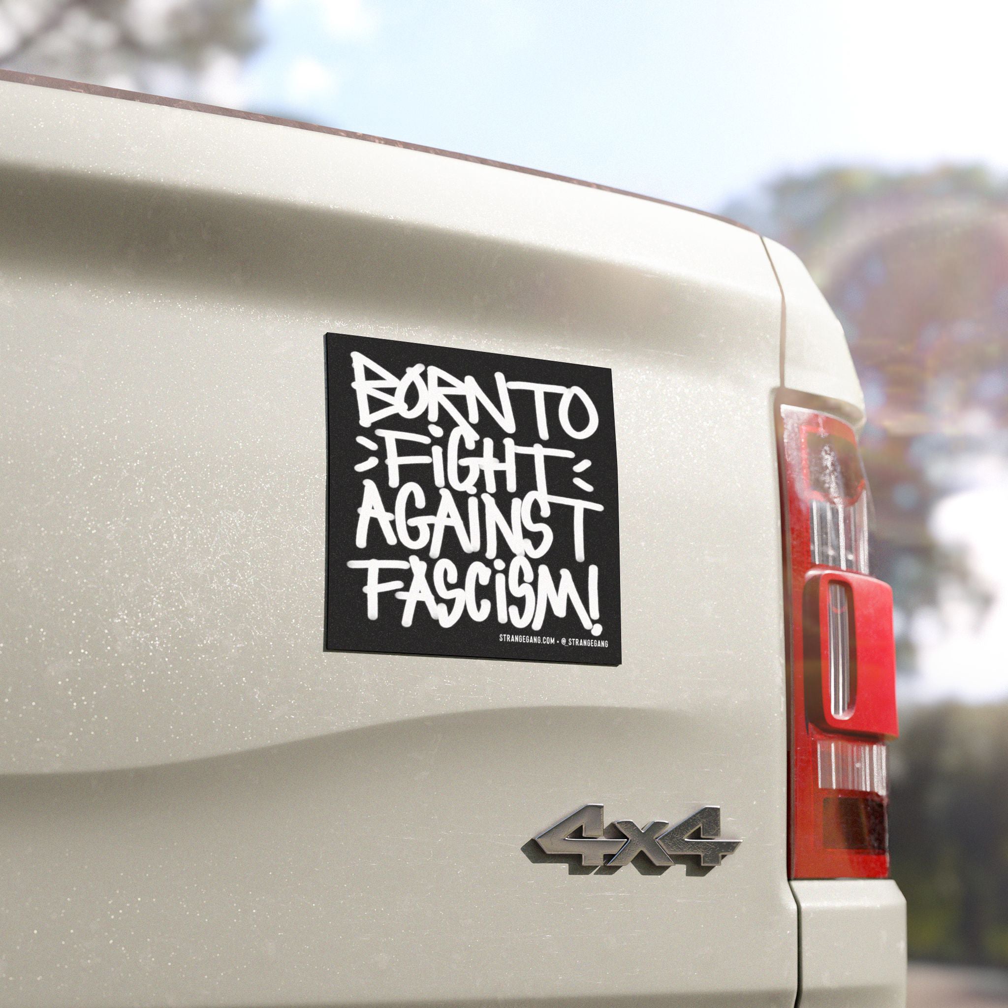 Born To Fight Against Fascism Graffiti Sticker & Magnet on a white 4x4 tailgate, featuring bold hand-lettering and a credit line, symbolizing defiant street art and resistance against oppression.