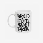 Born To Fight Against Fascism Graffiti Mug featuring a bold black graffiti-style slogan on a white ceramic surface, emphasizing resistance and activism. Handle visible on the left against a light backdrop.