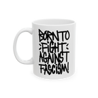 Born To Fight Against Fascism Graffiti Mug featuring a bold black graffiti-style slogan on a white ceramic surface, emphasizi