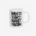 Born To Fight Against Fascism Graffiti Mug features a bold, hand-lettered slogan in black on a white ceramic surface, embodying resistance and activism. Available in two sizes, perfect for supporting equality and freedom.