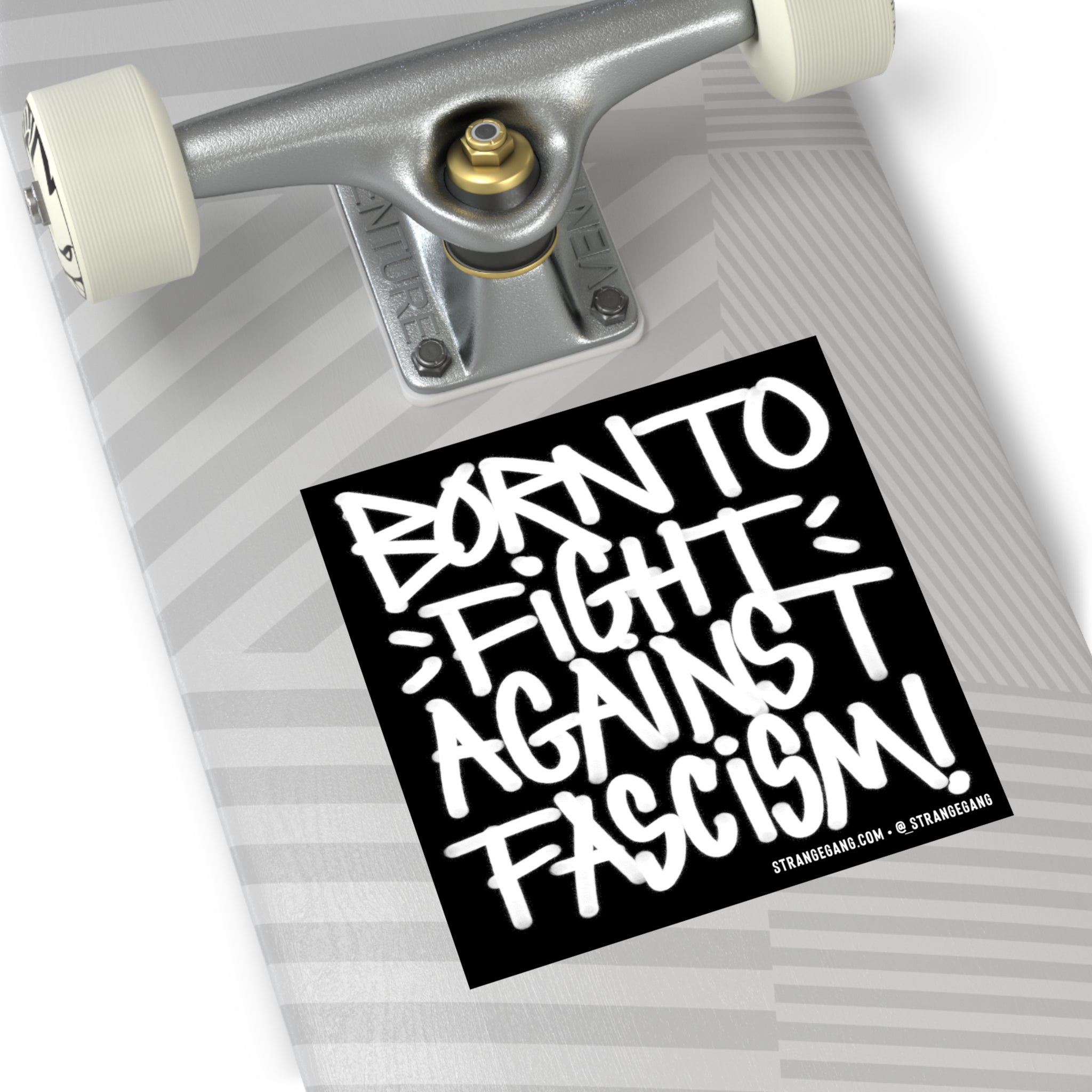 Skateboard deck with Born to Fight Against Fascism sticker, showcasing bold graffiti-style lettering. Product: a weatherproof vinyl sticker or magnet, ideal for laptops and bumpers.