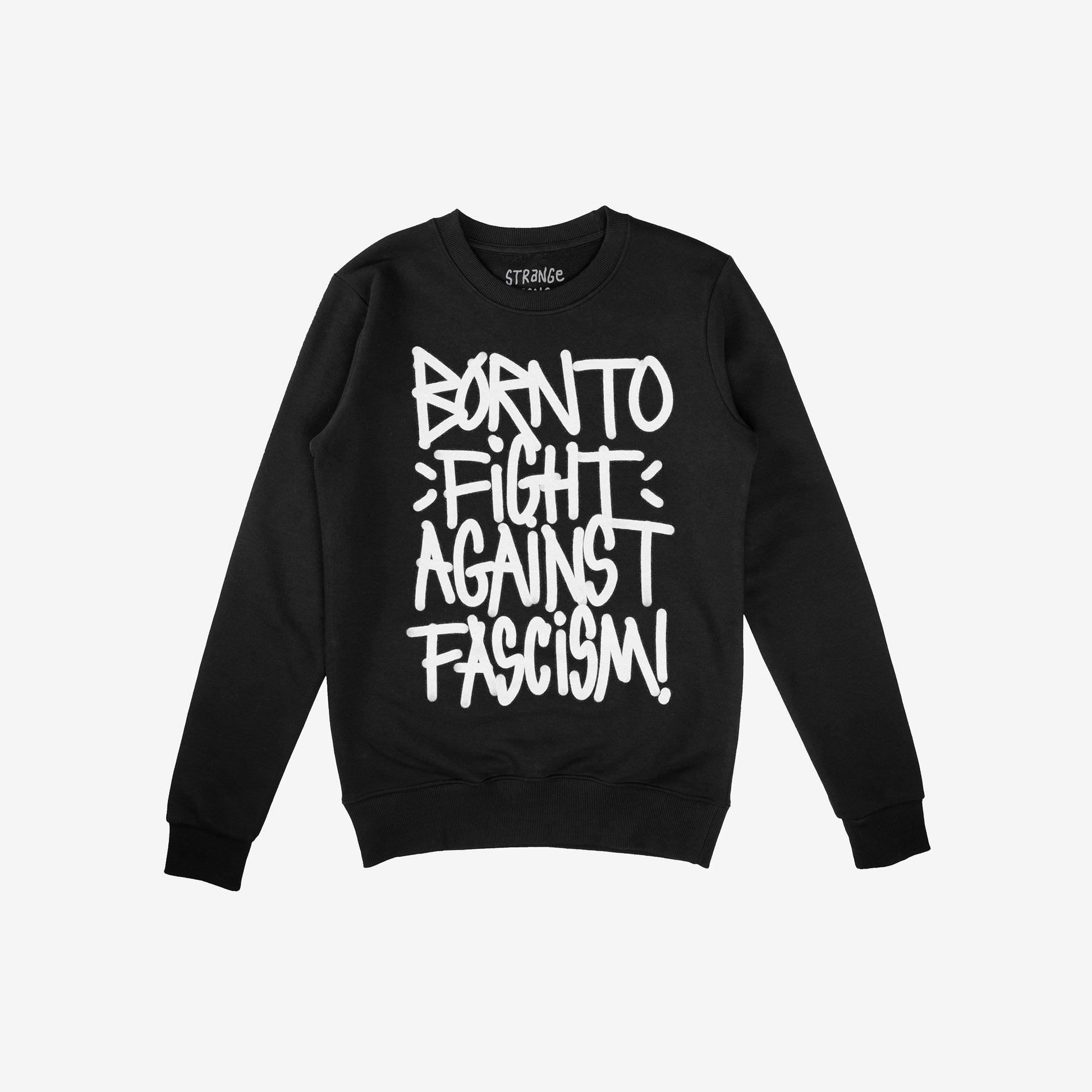 Black crew-neck sweatshirt with bold white graffiti text: “BORN TO FIGHT AGAINST FASCISM!”. Brand label at collar reads “STRANGE.”. Emphasizes protest spirit and benefits ACLU.