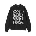 Black crew-neck sweatshirt with bold white graffiti text: “BORN TO FIGHT AGAINST FASCISM!”. Brand label at collar reads �