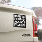The image displays the Born To Fight Against Fascism sticker on a 4×4 truck, featuring a bold, hand-drawn raised fist, conveying a strong anti-fascism message.