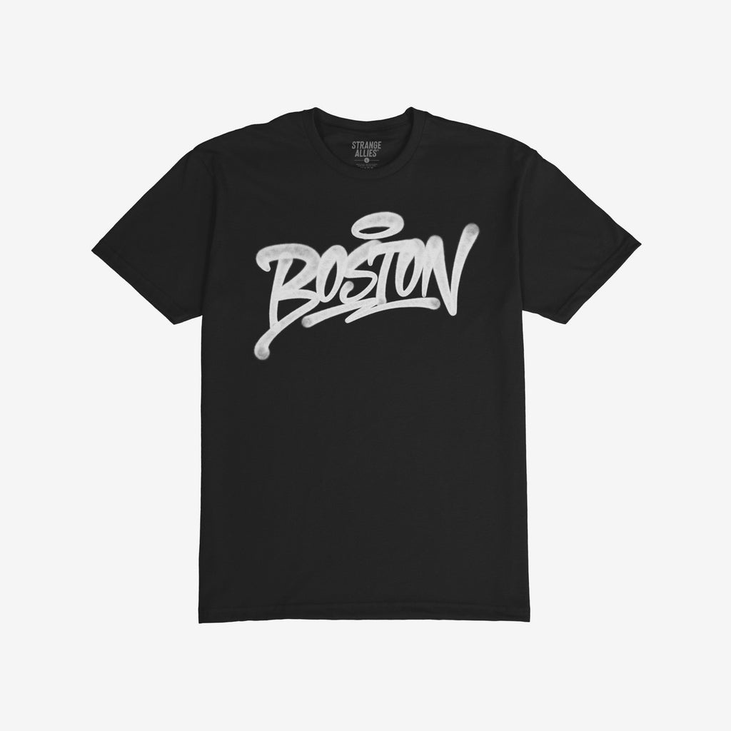 Boston Handstyle T-shirt features BOSTON in white graffiti script with a halo accent on a black crew-neck tee, reflecting a bold, authentic city statement. Inside label reads Strange Allies.