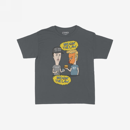 Breakin' The Law Women's Baby Tee showcases a satirical cartoon of Trump and Elon exchanging items with “BREAKIN’ THE LAW” text, capturing a rebellious punk aesthetic through humorous political commentary.