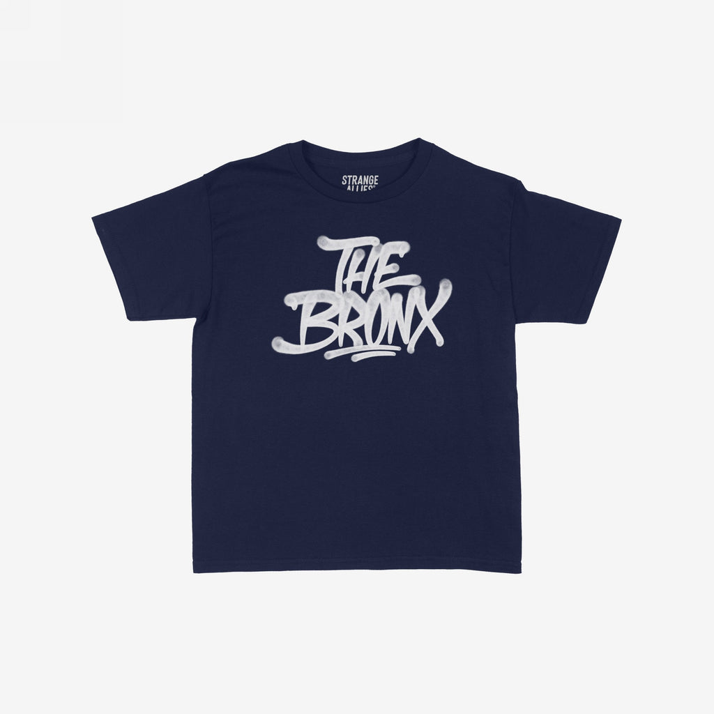 Bronx Handstyle Women's Baby Tee features a navy-blue, short-sleeve design with a white graffiti-style THE BRONX graphic, capturing raw borough pride and urban style.