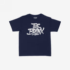 Bronx Handstyle Women's Baby Tee features a navy-blue, short-sleeve design with a white graffiti-style THE BRONX graphic, capturing raw borough pride and urban style.
