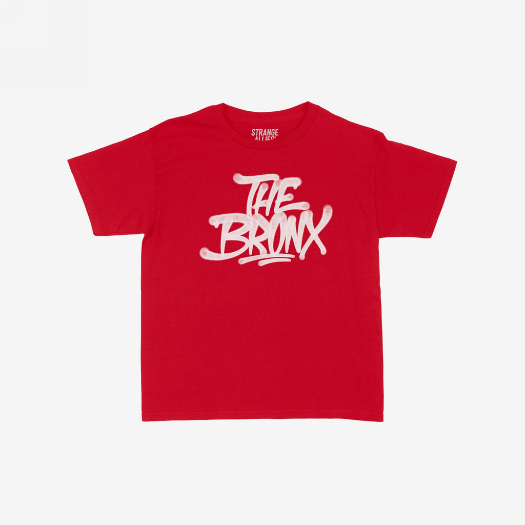 Bronx Handstyle Women's Baby Tee with graffiti-style THE BRONX graphic, capturing urban flair. Ideal for showcasing borough pride, this red T-shirt embodies NYC spirit and bold individuality.