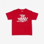 Bronx Handstyle Women's Baby Tee with graffiti-style THE BRONX graphic, capturing urban flair. Ideal for showcasing borough pride, this red T-shirt embodies NYC spirit and bold individuality.