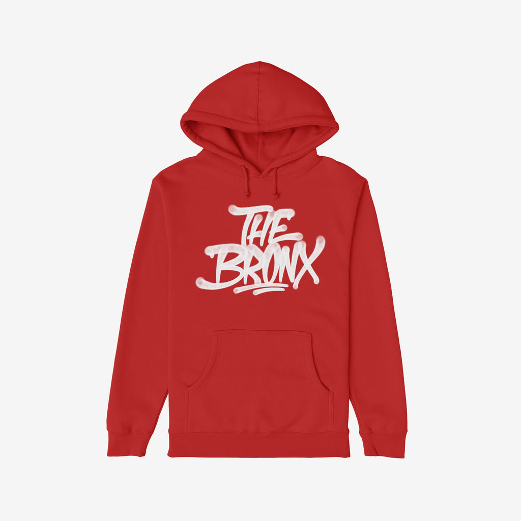 Red pullover Bronx Handstyle Hoodie featuring bold white graffiti-style THE BRONX lettering across the chest, with a front kangaroo pocket, embodying urban pride and resilience.
