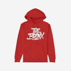 Red pullover Bronx Handstyle Hoodie featuring bold white graffiti-style THE BRONX lettering across the chest, with a front kangaroo pocket, embodying urban pride and resilience.