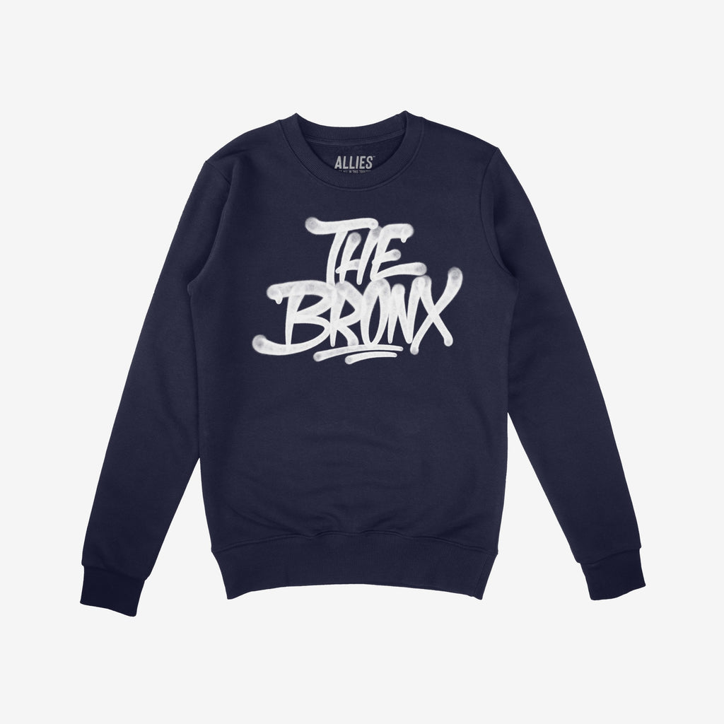 Navy-blue Bronx Handstyle Hoodie & Sweatshirt with “THE BRONX” in white graffiti font, embodying urban pride and resilience suitable for NYC winters, reflecting the store's values of equality and support.