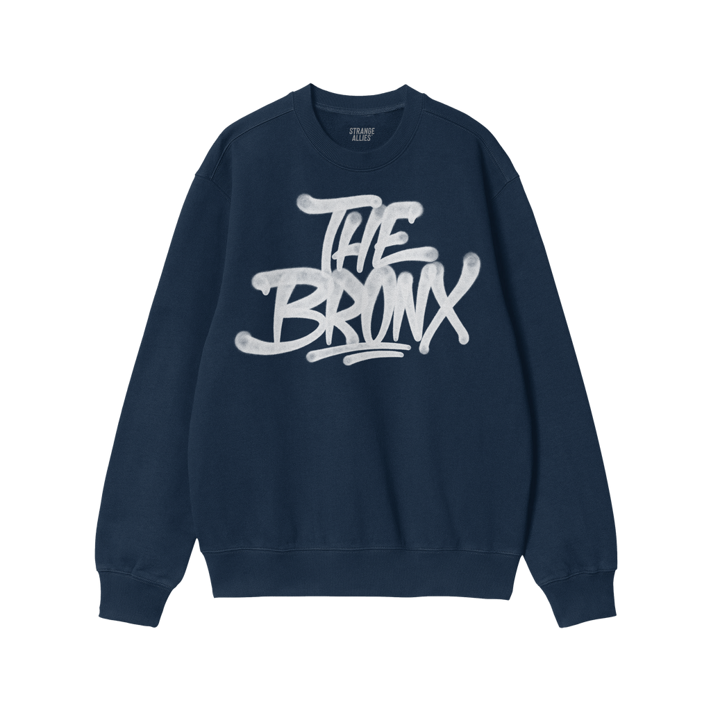 Navy-blue Bronx Handstyle Hoodie & Sweatshirt with “THE BRONX” in white graffiti font, embodying urban pride and resilien