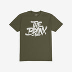 Bronx Handstyle T-shirt featuring bold white graffiti text THE BRONX on olive-green fabric, embodying raw urban pride and rebellion, perfectly aligned with the ethos of equality and anti-fascism.