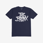 Bronx Handstyle T-shirt featuring a bold, white graffiti-style THE BRONX slogan on a dark navy-blue crew-neck, embodying borough pride and urban style. Ideal for NYC enthusiasts and locals.